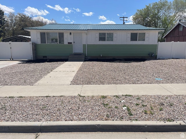 view of front of property with a gate, metal roof, fence, entry steps, and crawl space