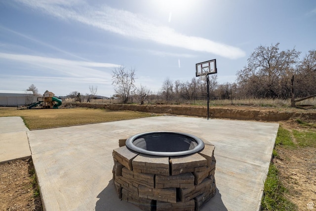 1394 S 1700 W, Vernal, UT 84078 - view of patio featuring basketball hoop, an outdoor fire pit, and a playground