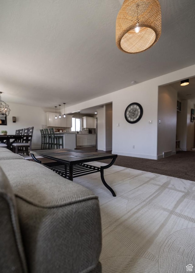 1394 S 1700 W, Vernal, UT 84078 - living room featuring carpet, baseboards, and a notable chandelier