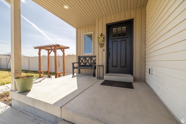 1394 S 1700 W, Vernal, UT 84078 - view of exterior entry with board and batten siding, a pergola, and fence