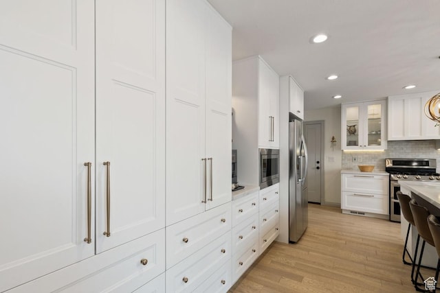 56 S 1000 E, Springville, UT 84663 - kitchen featuring stainless steel appliances, light countertops, light wood finished floors, recessed lighting, and white cabinetry