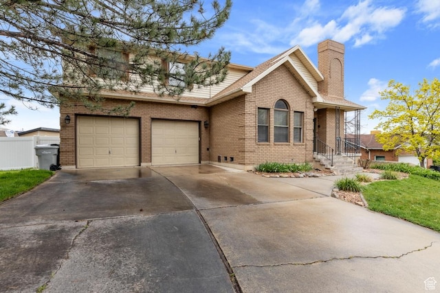 56 S 1000 E, Springville, UT 84663 - view of front of home with concrete driveway, brick siding, a chimney, an attached garage, and roof with shingles