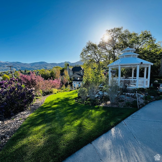 view of yard with a mountain view and a gazebo