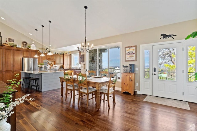 dining space with dark wood-type flooring, recessed lighting, lofted ceiling, and a chandelier