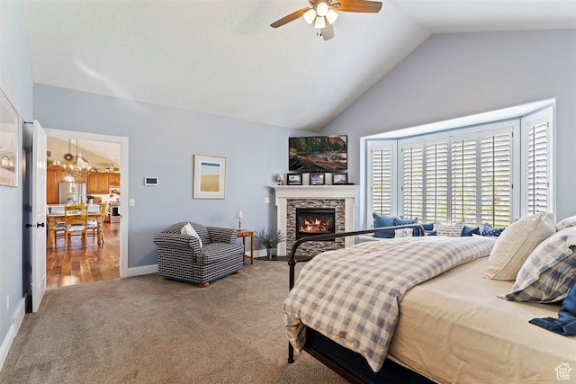 bedroom with a fireplace, vaulted ceiling, baseboards, freestanding refrigerator, and carpet