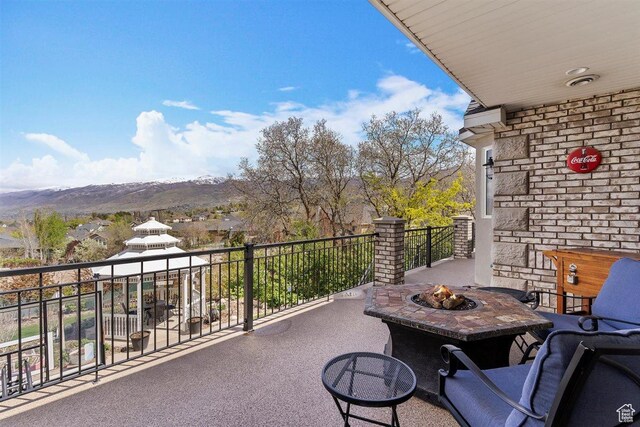 balcony featuring a fire pit and a mountain view