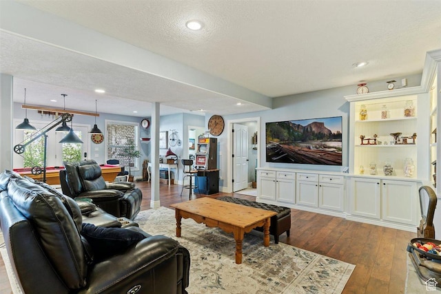living area featuring recessed lighting, a textured ceiling, and dark wood-type flooring