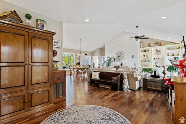 interior space with recessed lighting, high vaulted ceiling, ceiling fan with notable chandelier, and dark wood finished floors