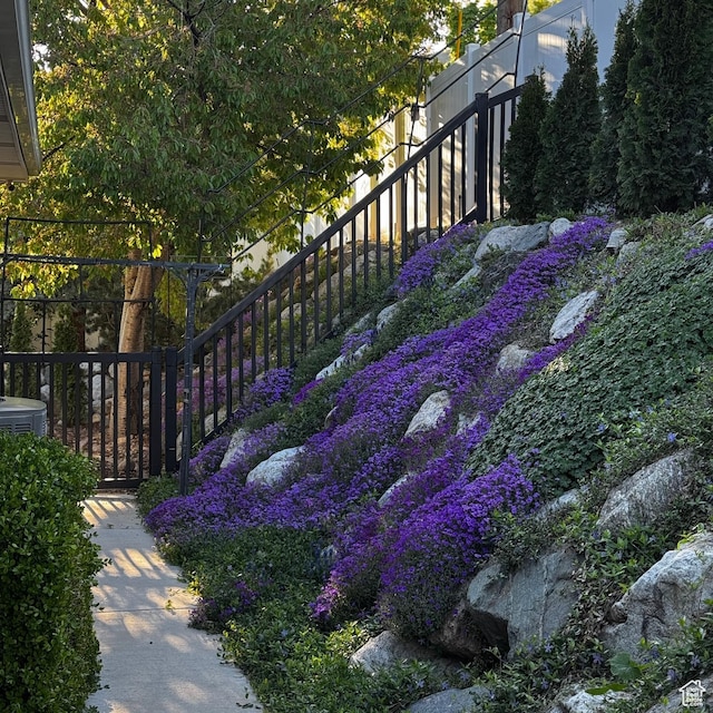 view of yard with stairs and central AC