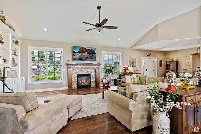 living area featuring ceiling fan, dark wood finished floors, a wealth of natural light, and lofted ceiling