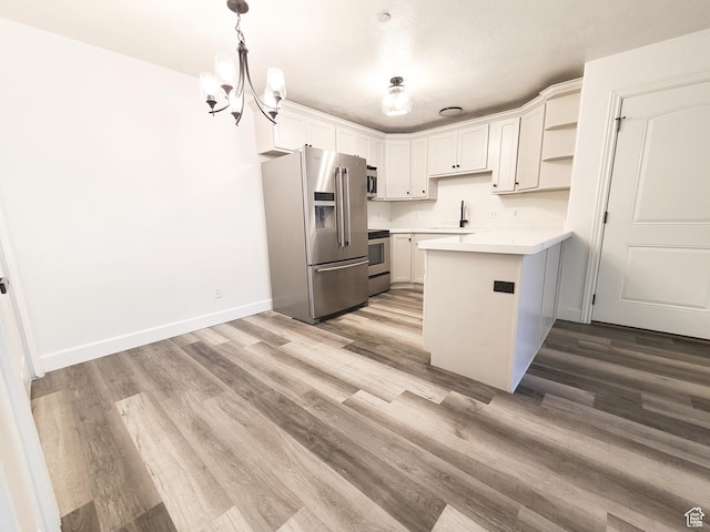317 S 1000 W Unit 103, Pleasant Grove, UT 84062 - kitchen with light countertops, open shelves, a sink, a peninsula, and appliances with stainless steel finishes