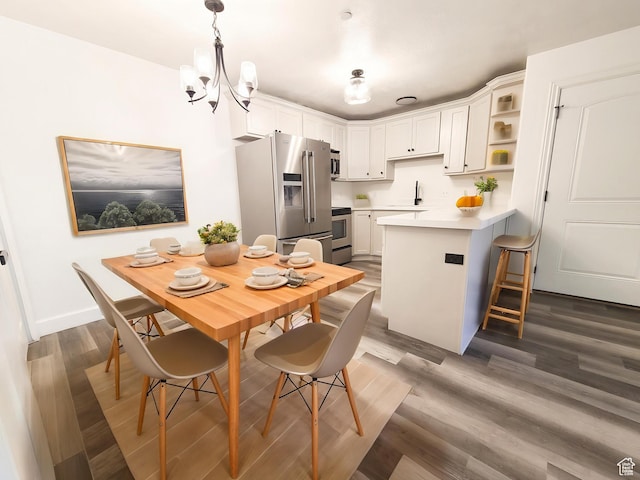 317 S 1000 W Unit 103, Pleasant Grove, UT 84062 - kitchen featuring a kitchen breakfast bar, a sink, stainless steel appliances, white cabinets, and a peninsula