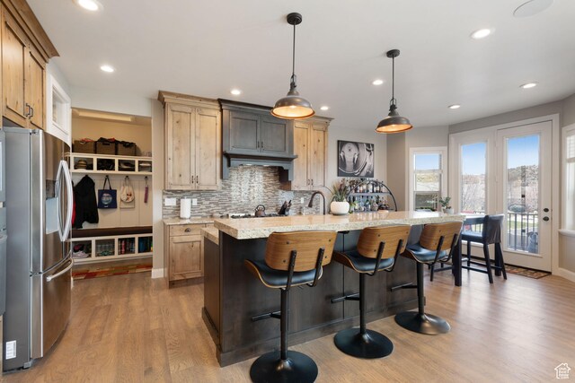 4423 Ranch Blvd, Mountain Green, UT 84050 - kitchen with stainless steel fridge, tasteful backsplash, dark wood-type flooring, a kitchen breakfast bar, and recessed lighting