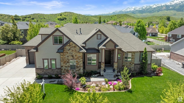 4423 Ranch Blvd, Mountain Green, UT 84050 - view of front of house featuring driveway, stone siding, a mountain view, and a residential view