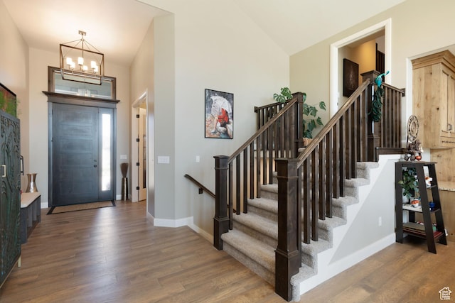 4423 Ranch Blvd, Mountain Green, UT 84050 - foyer entrance featuring a chandelier, wood finished floors, stairs, baseboards, and a high ceiling