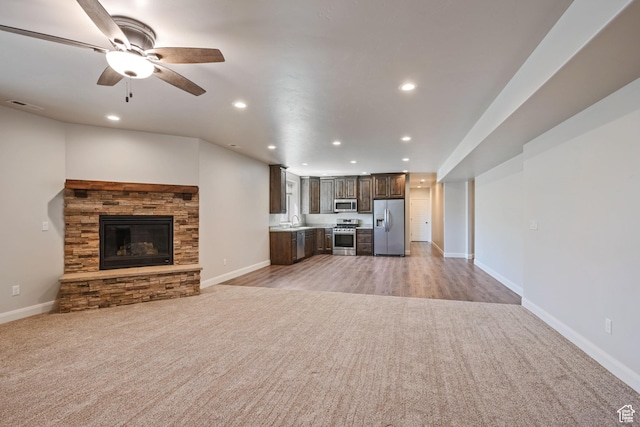 4423 Ranch Blvd, Mountain Green, UT 84050 - unfurnished living room featuring light carpet, recessed lighting, a sink, baseboards, and ceiling fan