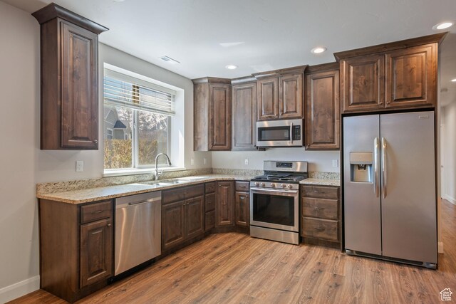 4423 Ranch Blvd, Mountain Green, UT 84050 - kitchen featuring stainless steel appliances, a sink, light wood finished floors, recessed lighting, and dark brown cabinetry
