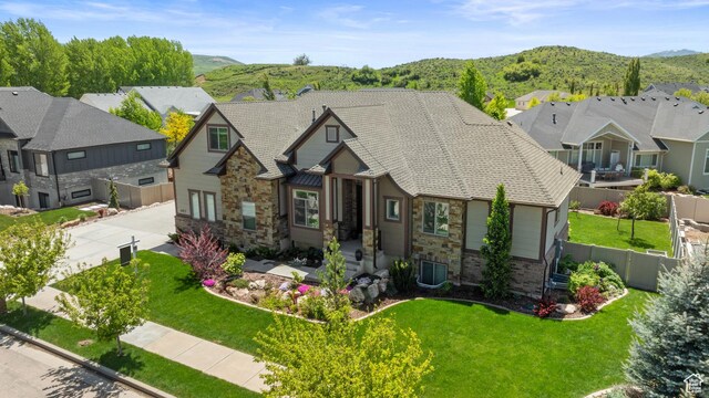 4423 Ranch Blvd, Mountain Green, UT 84050 - view of front facade with stone siding, a mountain view, a residential view, and driveway