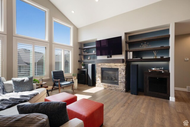 4423 Ranch Blvd, Mountain Green, UT 84050 - living area with high vaulted ceiling, a stone fireplace, wood finished floors, and recessed lighting