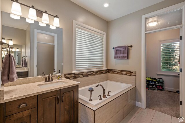 4423 Ranch Blvd, Mountain Green, UT 84050 - full bathroom with vanity, a garden tub, baseboards, and recessed lighting
