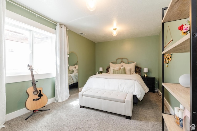 bedroom featuring baseboards, visible vents, and carpet