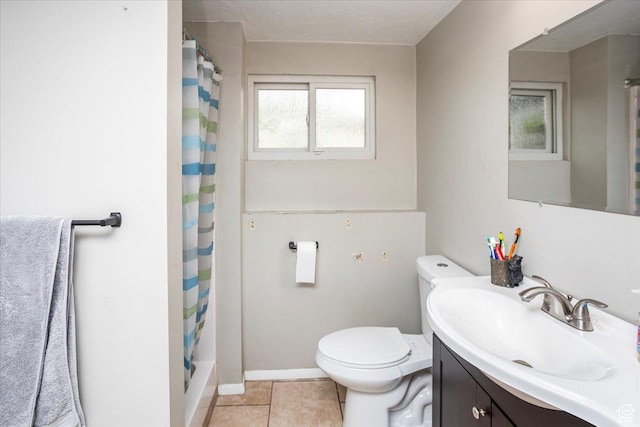 bathroom featuring tile patterned floors, vanity, curtained shower, baseboards, and toilet
