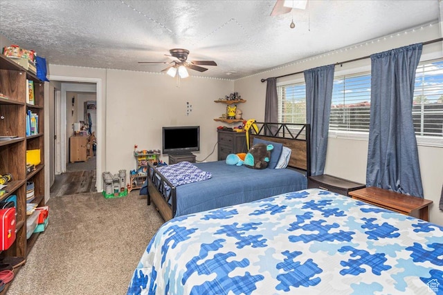bedroom with a ceiling fan, carpet, and a textured ceiling