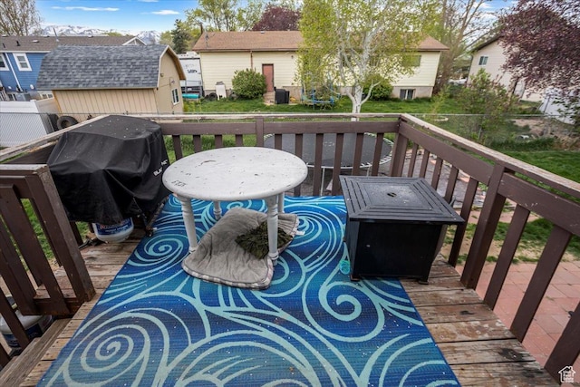 wooden deck featuring area for grilling and a residential view