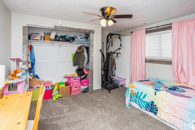 carpeted bedroom featuring a textured ceiling, a closet, and ceiling fan