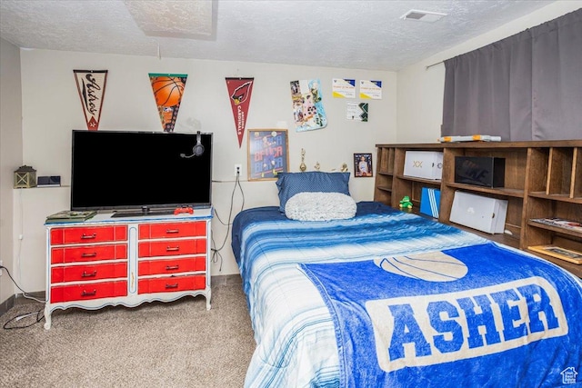 bedroom featuring a textured ceiling, carpet, and visible vents