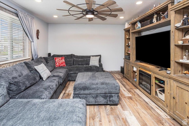 living area with a ceiling fan, light wood finished floors, and recessed lighting
