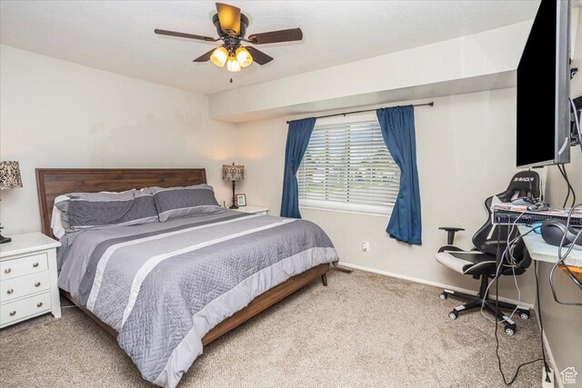 bedroom with carpet floors, a ceiling fan, and baseboards