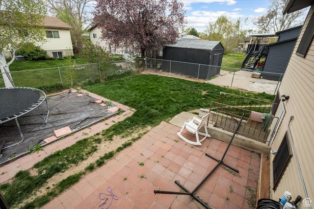 view of yard with a patio area, a fenced backyard, and stairs