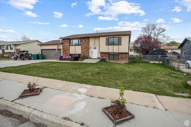 raised ranch featuring concrete driveway, fence, brick siding, an attached garage, and a front yard