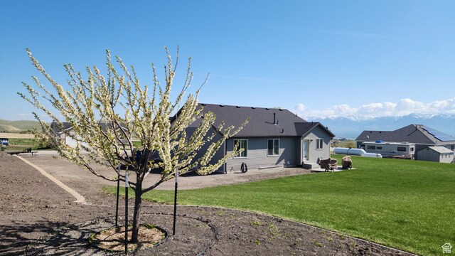 8050 W 1900 N, Petersboro, UT 84325 - rear view of house featuring a lawn and a patio