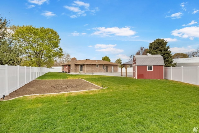 view of yard with a patio area, a fenced backyard, an outbuilding, and a shed