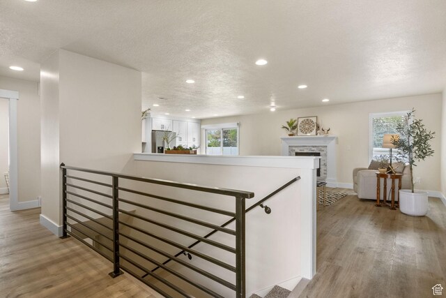 interior space featuring white cabinets, light wood-style flooring, baseboards, and recessed lighting