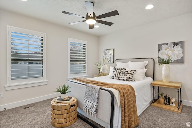 carpeted bedroom featuring baseboards, a ceiling fan, visible vents, and recessed lighting