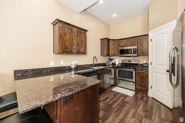 111 E 690 S, Smithfield, UT 84335 - kitchen with appliances with stainless steel finishes, dark stone countertops, a peninsula, dark wood-type flooring, and dark brown cabinets