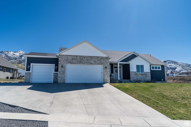 16 N 1000 E, Hyde Park, UT 84318 - ranch-style home with a mountain view, driveway, stone siding, an attached garage, and a front yard
