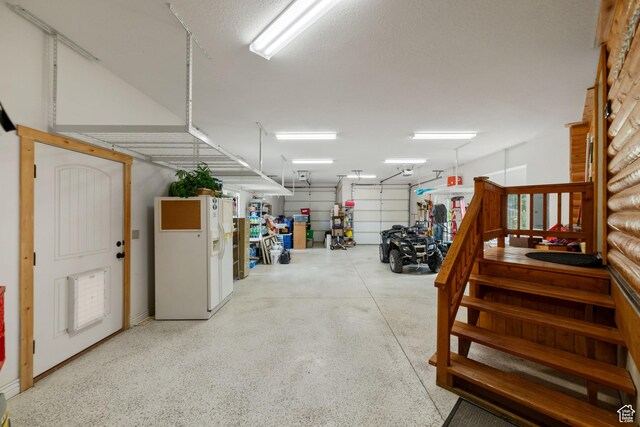 2592 S 2900 E, New Harmony, UT 84757 - garage with white refrigerator with ice dispenser and a garage door opener