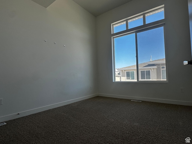 5487 W Fade Ct S, West Valley City, UT 84120 - spare room featuring baseboards, dark colored carpet, and visible vents