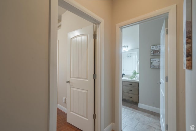 hall featuring baseboards