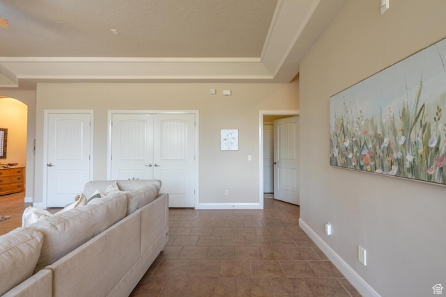 living room featuring arched walkways and baseboards
