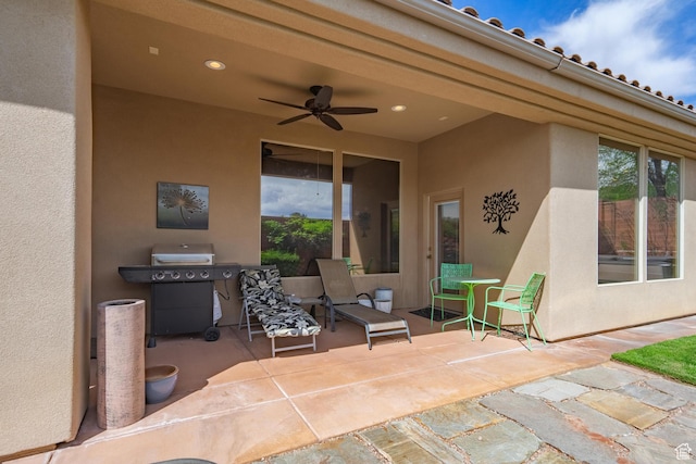 view of patio featuring ceiling fan and a grill