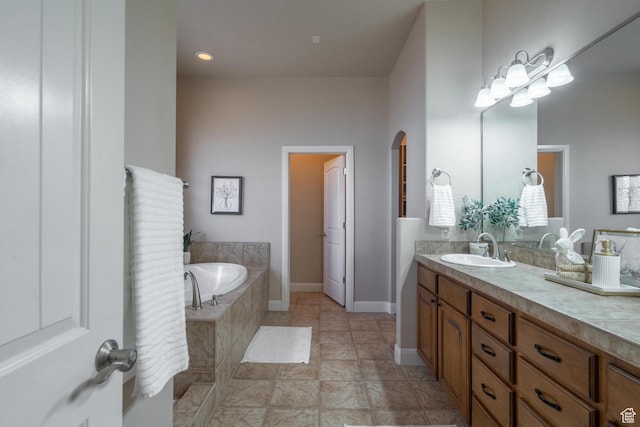 full bath featuring a garden tub and vanity
