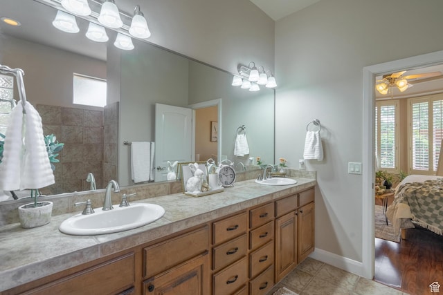 bathroom featuring connected bathroom, double vanity, tile patterned floors, and baseboards
