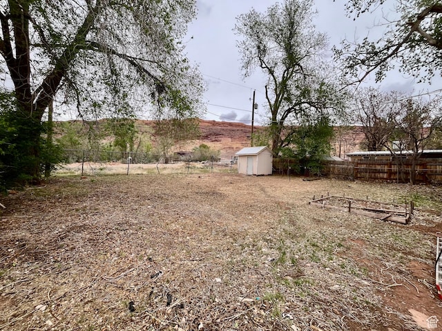736 Westwood Ave, Moab, UT 84532 - view of yard featuring fence, an outbuilding, and a shed