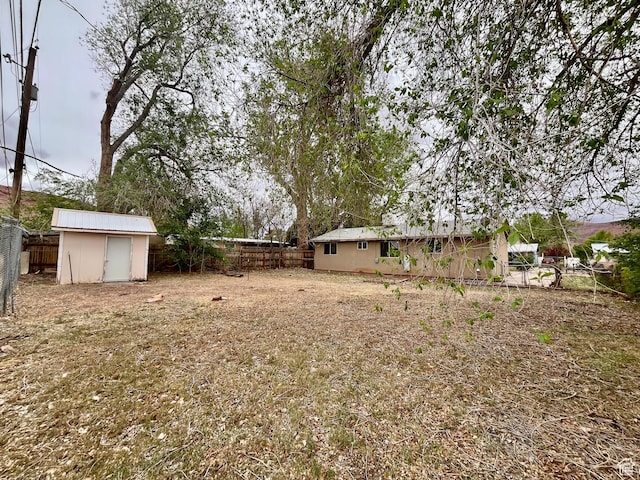 736 Westwood Ave, Moab, UT 84532 - view of yard featuring a storage shed, a fenced backyard, and an outdoor structure