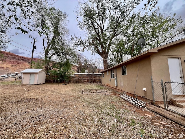 736 Westwood Ave, Moab, UT 84532 - view of yard featuring an outdoor structure, a storage unit, and a fenced backyard